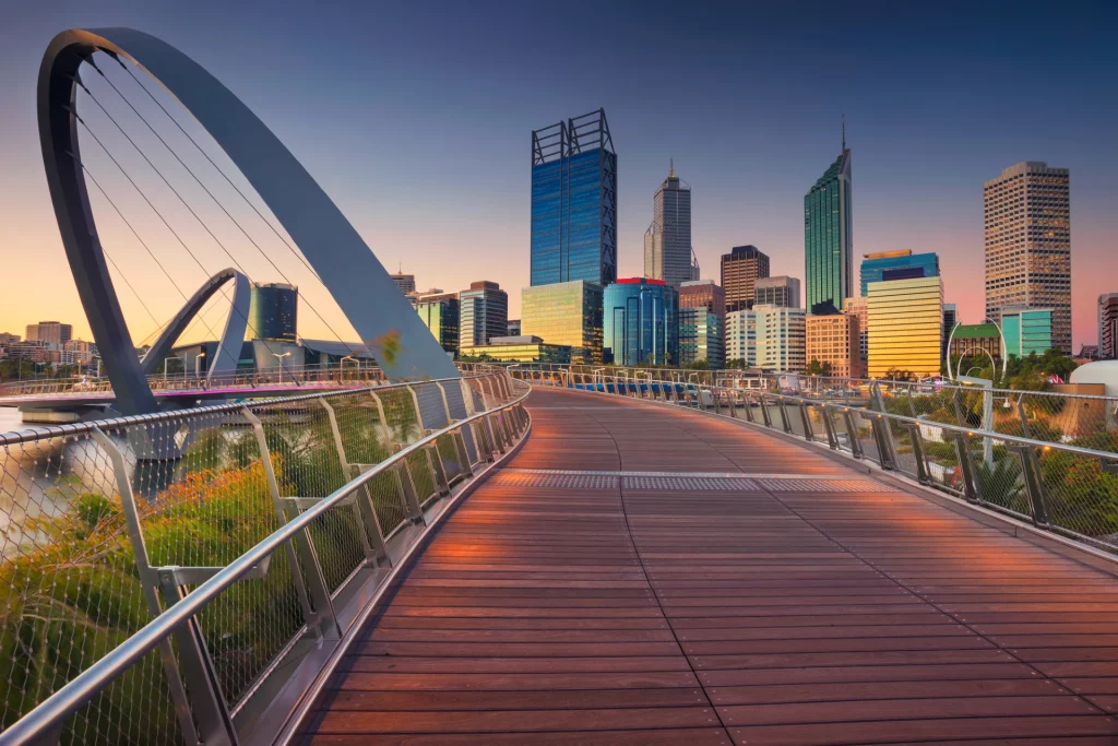 architectural image of perth boardwalk, coloured buildings in and bridges in the background