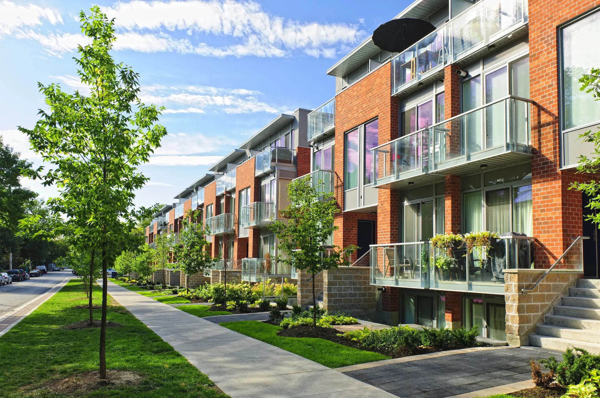 image of a row of townhouses along a suburban street