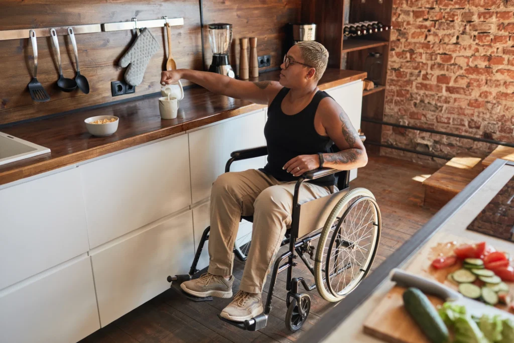 image of a person in a wheelchair making a coffee in their kitchen